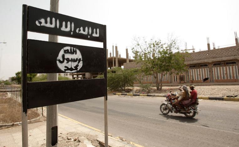 An al-Qaeda logo is seen on a street sign in the town of Jaar in southern Abyan province, Yemen