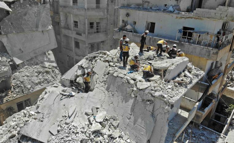 Members of the Syrian Civil Defence (White Helmets) search for victims at the site of a reported air strike on the town of Ariha