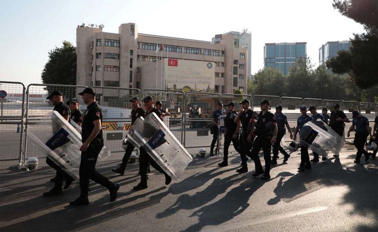Turkish police walk in front of the Metropolitan Municipality headquarters in Diyarbakir
