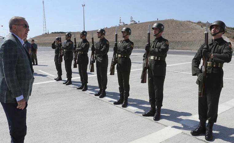 Erdogan inspects a military honour guard before addressing his supporters in Bursa, Turkey