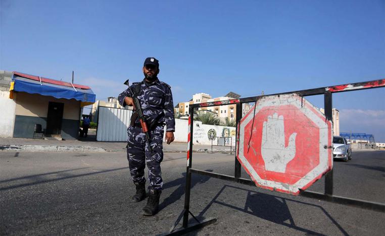 A Palestinian policeman stands guard at a checkpoint in Khan Younes