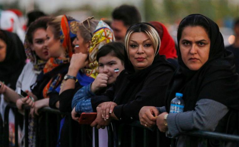 Iranian women wearing facepaint of the national flag arrive outside Azadi stadium in the capital Tehran