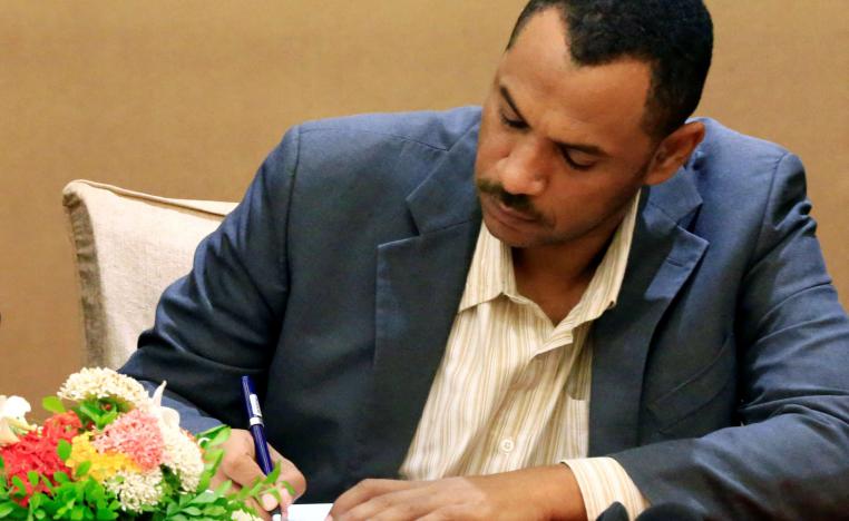 Sudanese leader of the protest movement Ahmad al-Rabiah signs a constitutional declaration in Khartoum