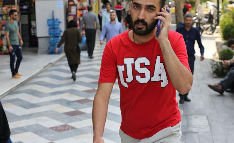 A man uses his mobile telephone at the Vali Asr square in the Iranian capital Tehran