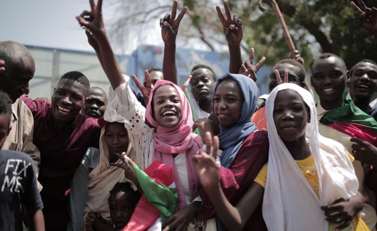 Sudanese men and women celebrate outside the Friendship Hall in the capital Khartoum