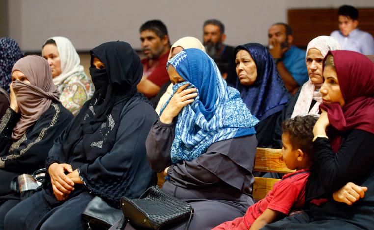 Libyans attend a meeting with charity workers at a gym in the capital Tripoli