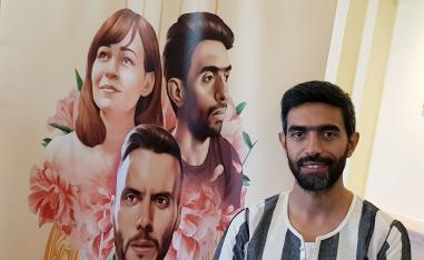 بطل الفيلم عمرو عابد يقف بجانب الملصق الدعائي لفيلمه في مهرجان الجونة السينمائي
