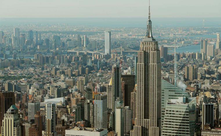 The Empire State Building rises above Manhattan in front of the Brooklyn and Manhattan bridges