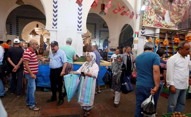A woman sells plastic bags in a downtown market in Tunis