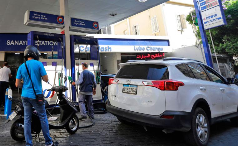 Drivers fill up at a petrol station in the Lebanese capital Beirut on September 27