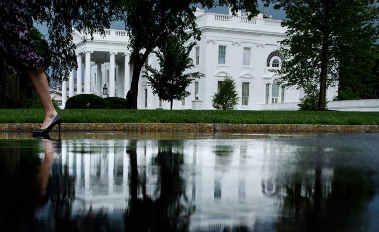 A person walks past the White House in Washington, DC