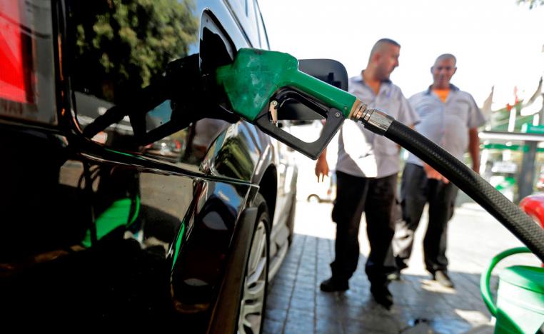 A driver fills his tank at a petrol station in the Lebanese capital Beirut