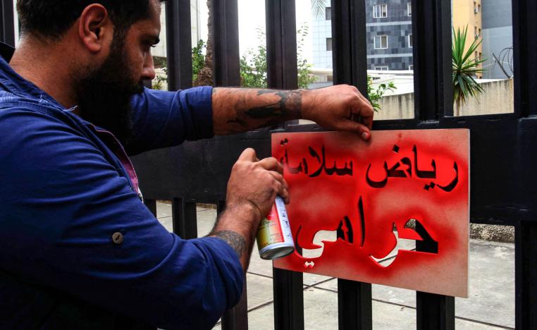 محتج لبناني ينسخ شعارا ضد الفساد