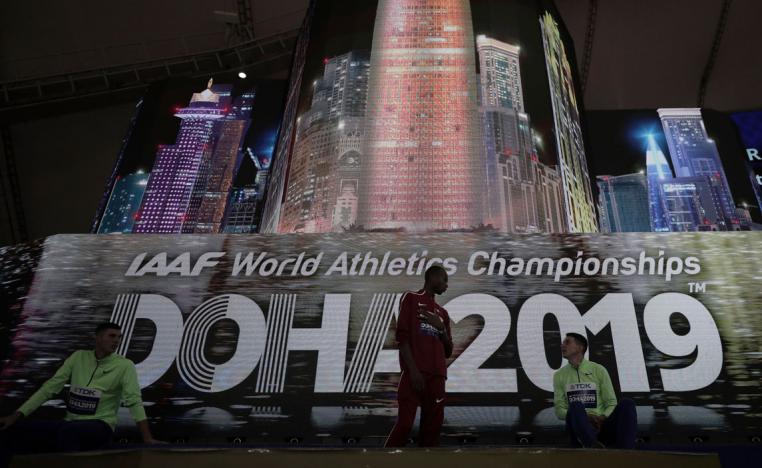 Athletes speak on the podium after the medal ceremony for the the men's high jump final was postponed
