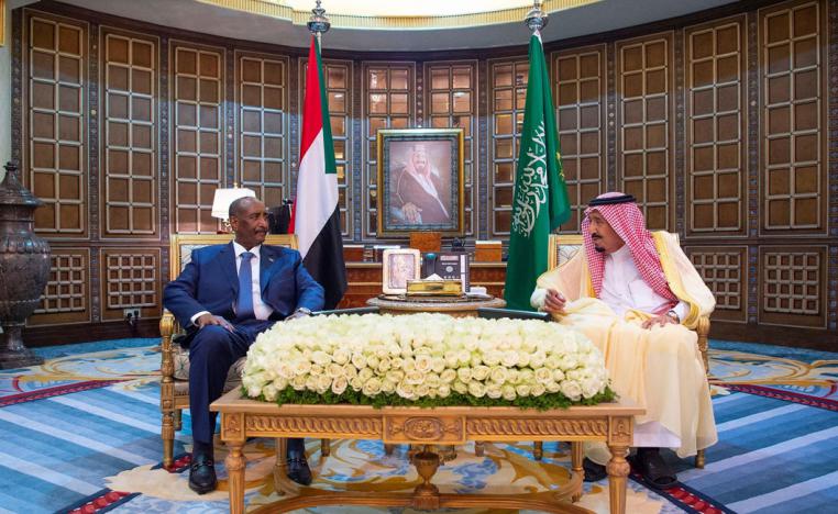Saudi King Salman bin Abdulaziz Al Saud (L) speaks with Leader of the Sovereignty Council of Sudan Abdel Fattah al-Burhan