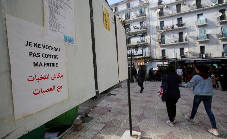 No elections with gangs, reads the poster in Arabic