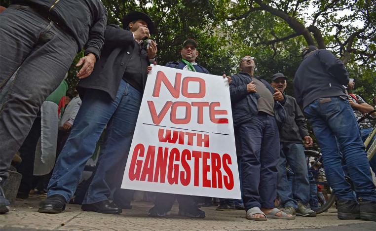 Algerian protesters hold a placard as they take part in an anti-government demonstration in Algiers