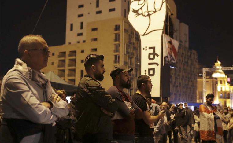 Anti-government protesters listen to Lebanese President's speech
