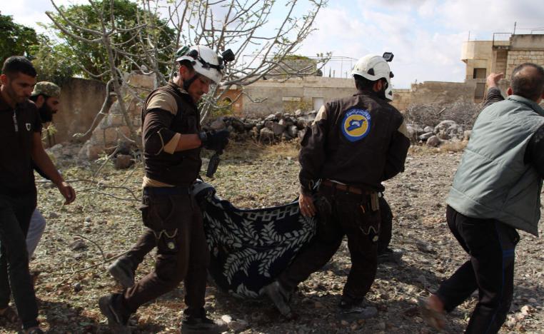 Members of the Syrian Civil Defence (White Helmets) carry away one of the victims of a Russian airstrike that hit the village of Jaballa