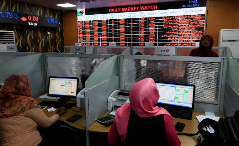 Women work at the Khartoum Stock Exchange in Khartoum, Sudan