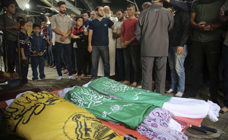 Mourners prepare for prayers over the bodies of Rafat Ayyad and his two sons, who were killed in an Israeli airstrike in Gaza City