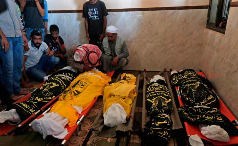 Palestinians mourn over the bodies of members of the same family who were killed overnight in an Israeli airstrike