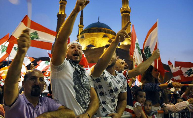 Anti-government protesters wave Lebanese flags and chant slogans, during ongoing demonstrations, in Beirut
