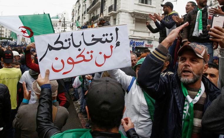 Banner raised at anti-government protests in Algiers reads "your elections will not take place"