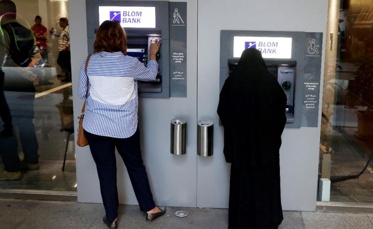 Women use ATMs at Blom bank in Beirut