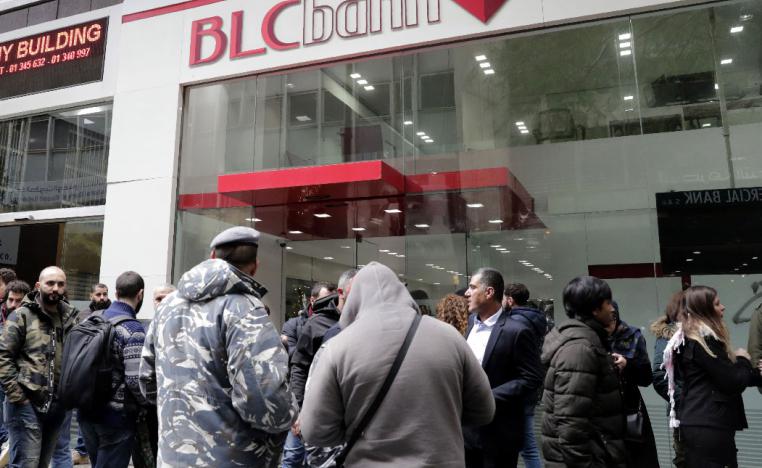 Lebanese protesters occupy a branch of BLC Bank in the capital Beirut