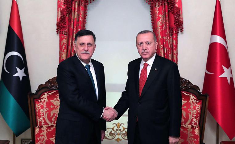 Turkish President Recep Tayyip Erdogan (R) shaking hands with Fayez al-Sarraj (L)