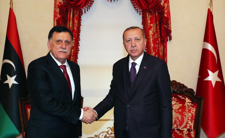 Turkish President Recep Tayyip Erdogan (R) shakes hands with head of Libya's UN-backed government, Fayez al-Sarraj
