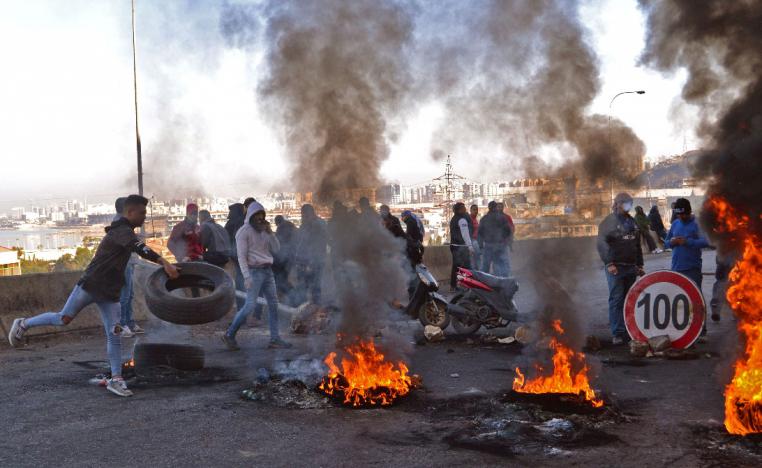 Lebanese protesters block a road in the northern city of Tripoli