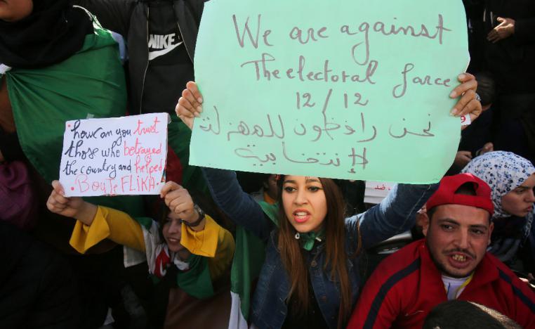 Demonstrators shout slogans during a protest calling to reject the presidential election in Algiers