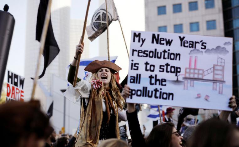 A protester holds a placard as she takes part in a demonstration against Israel's offshore Leviathan natural gas field