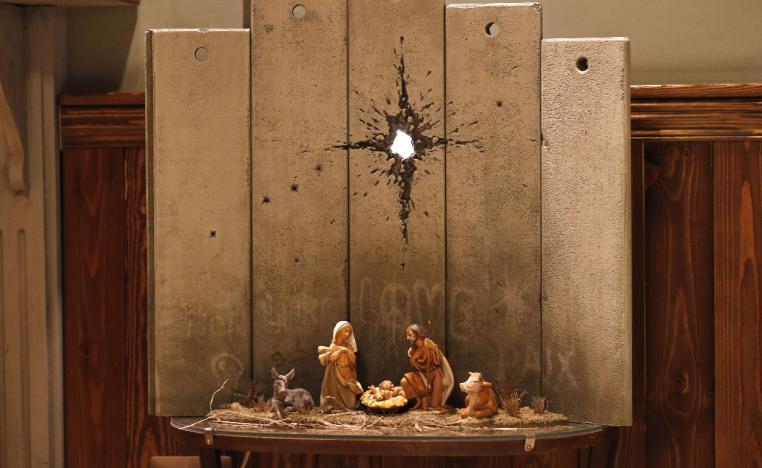 A new Christmas-themed artwork dubbed the "Scar of Bethlehem" by secretive British artist Banksy is displayed at his Walled-Off Hotel in Bethlehem