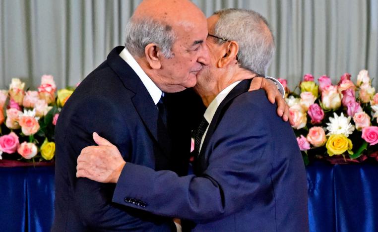 Algerian President-elect Abdelmadjid Tebboune (L) greets interim president Abdelkader Bensalah (R)