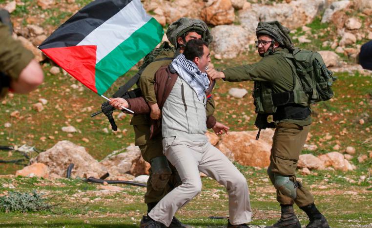 A Palestinian demonstrators is detained by Israeli soldiers during a demonstration near the West Bank village of Tubas