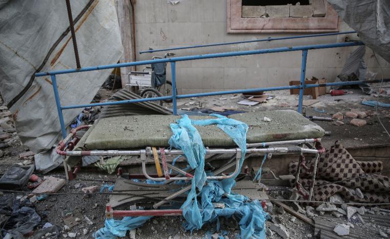 A hospital bed lies amongst the rubble of the damaged Shami Clinic in Ariha