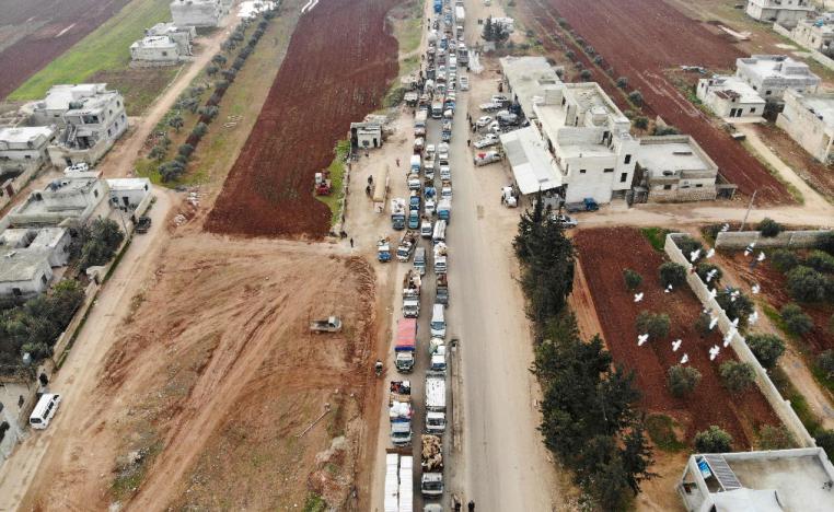 A aerial photo shows displaced Syrians driving through Hazano in the northern countryside of Idlib