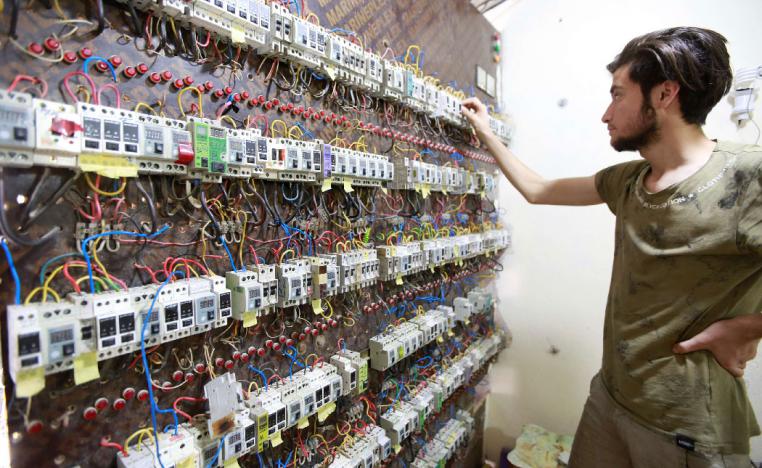 A worker is seen near an electrical generator board in Najaf, Iraq