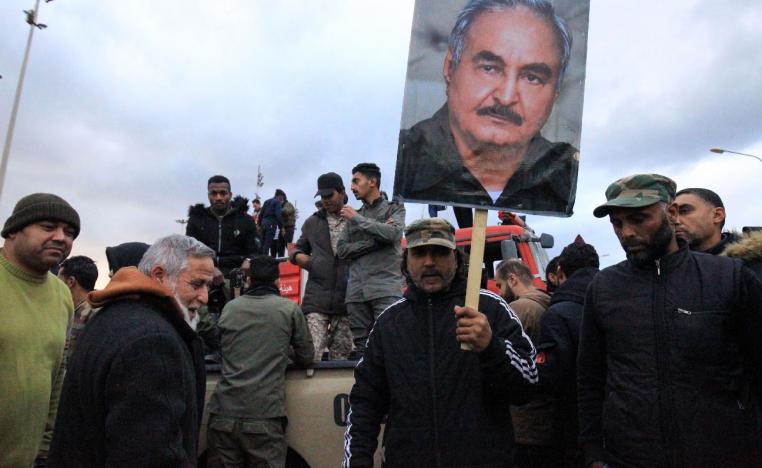 People raise a picture of Libyan strongman Khalifa Haftar as they take part in a demonstration held in the eastern Libyan city of Benghazi