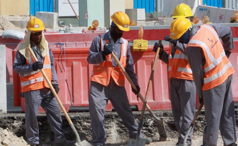 Workers are seen at a construction site in Doha
