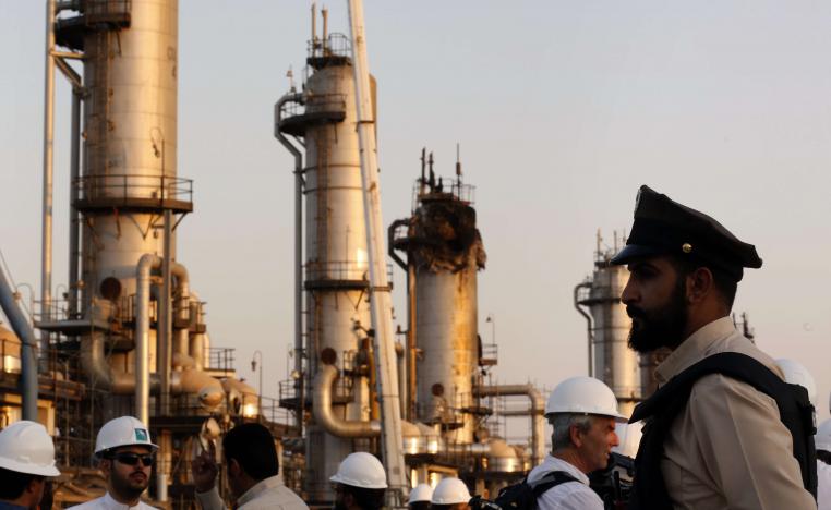A security guard stands alert in front of Aramco's oil processing facility