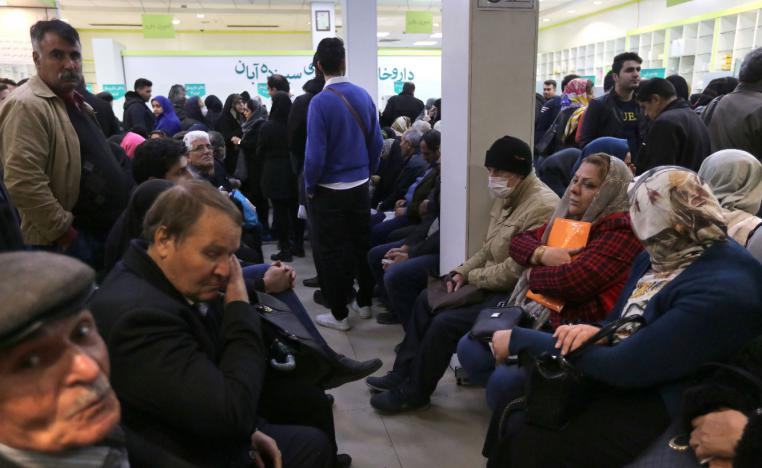 Iranians wait to get prescription drugs at the state-run "13 Aban" pharmacy in Tehran