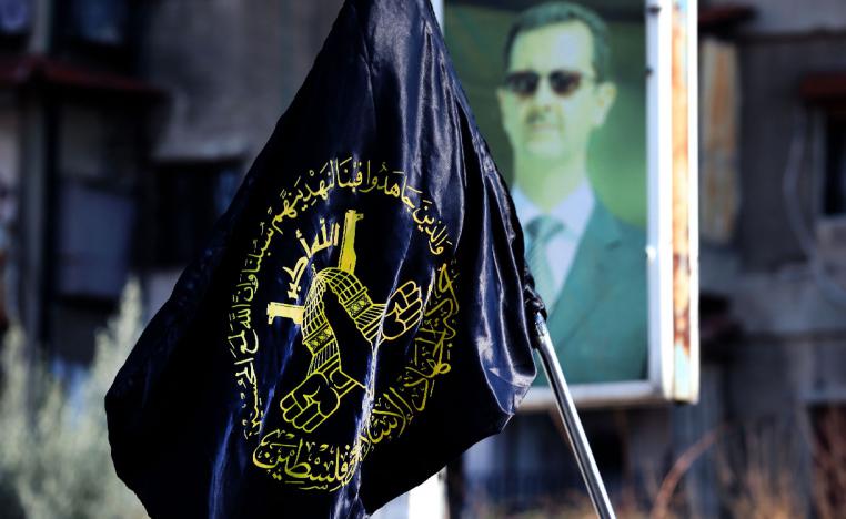 Mourners carry the flag of Islamic Jihad during the funeral of two members at Yarmuk, a Palestinian refugee camp south of Damascus