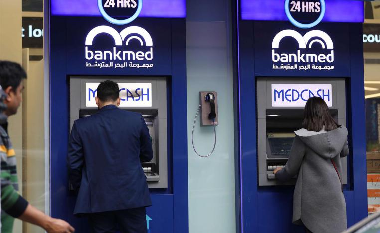 A Lebanese man withdraws money from a ATM in the capital Beirut 