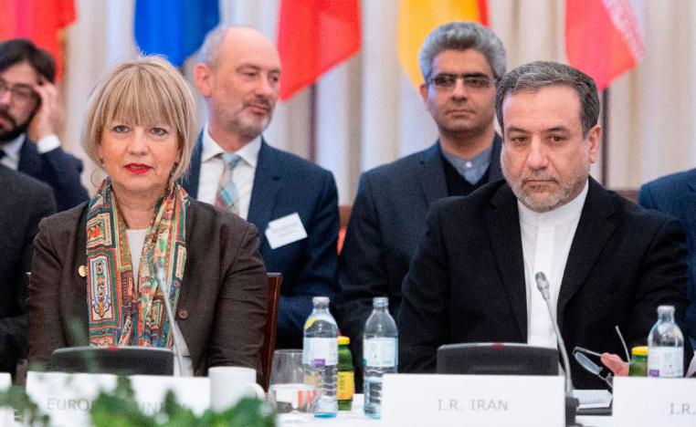 Abbas Araghchi (R), political deputy at the Ministry of Foreign Affairs of Iran, and the Secretary General of the European Union External Action Service (EEAS) Helga Schmid attend a meeting in Vienna