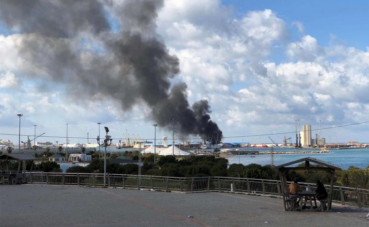 A smoke rises from a port of Tripoli after being attacked