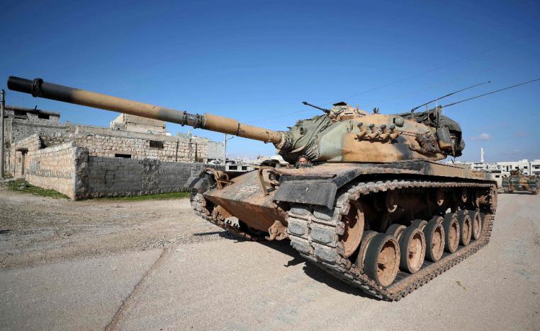 A Turkish army US-made M60 tank drives in the town of Sarmin